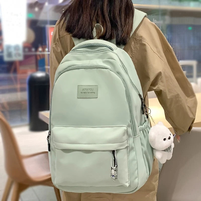 Water-resistant school backpack with multiple compartments for books and laptop