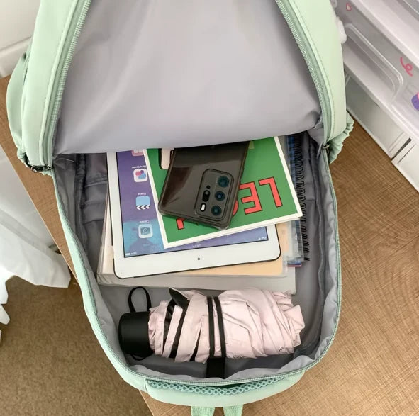Water-resistant school backpack with multiple compartments for books and laptop
