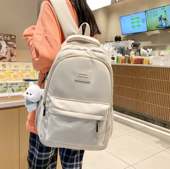 Water-resistant school backpack with multiple compartments for books and laptop